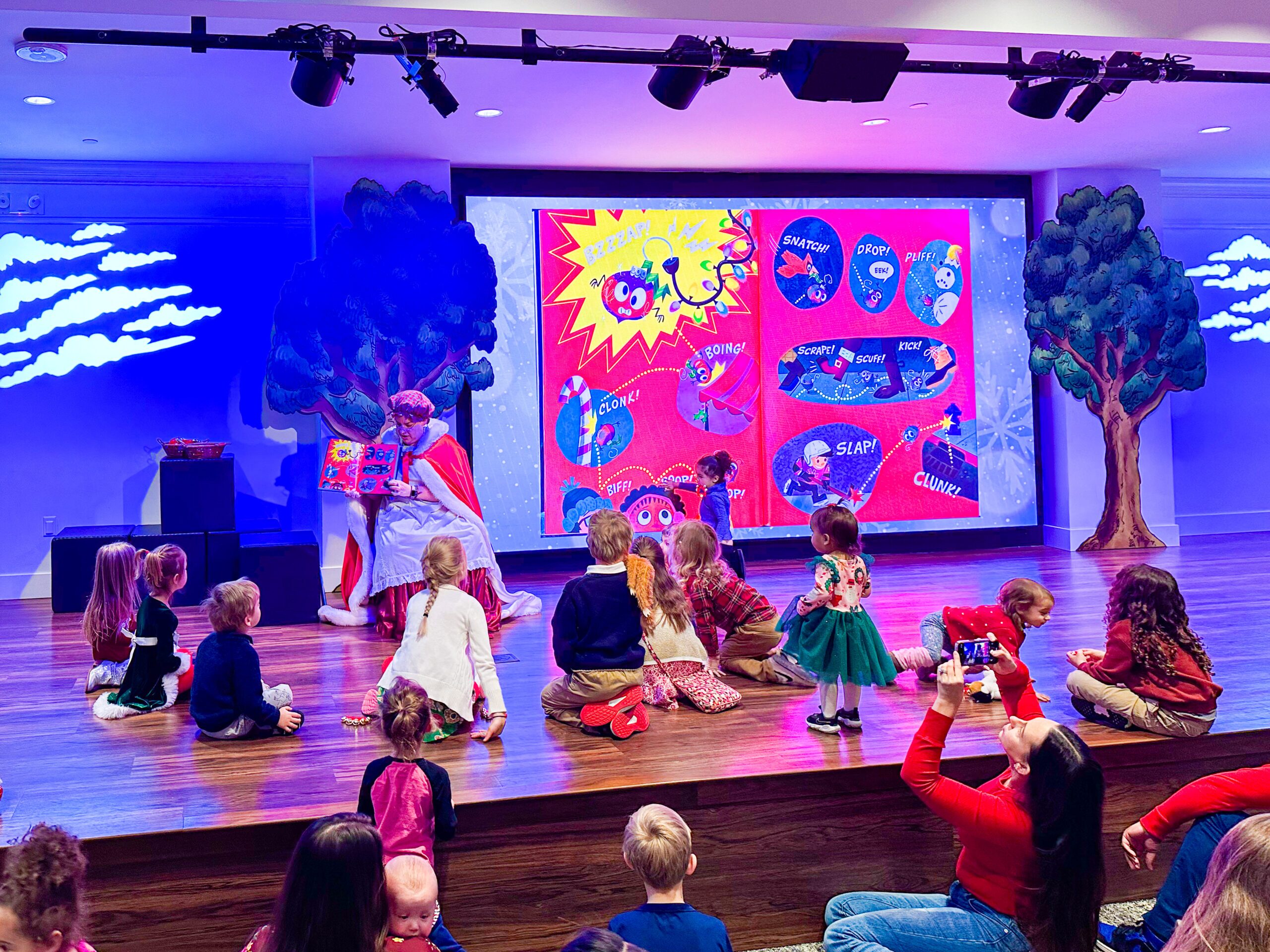 Mrs. Claus reads a story to kids in Story Time Theater