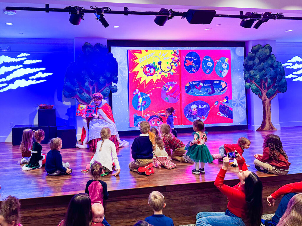 Mrs. Claus reads a story to kids in Story Time Theater